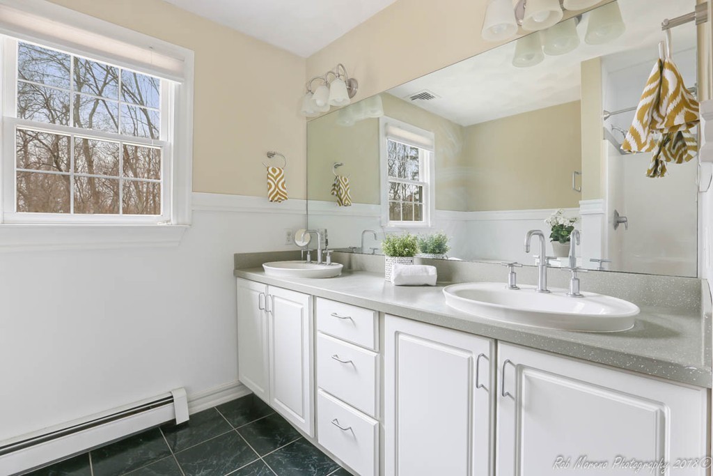 295 South Main Street Andover, MA 01810 - Photo 20 of 30 a bathroom with a double vanity sink and a mirror
