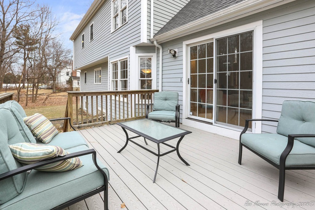 295 South Main Street Andover, MA 01810 - Photo 6 of 30 a balcony with couches and a potted plant on a table