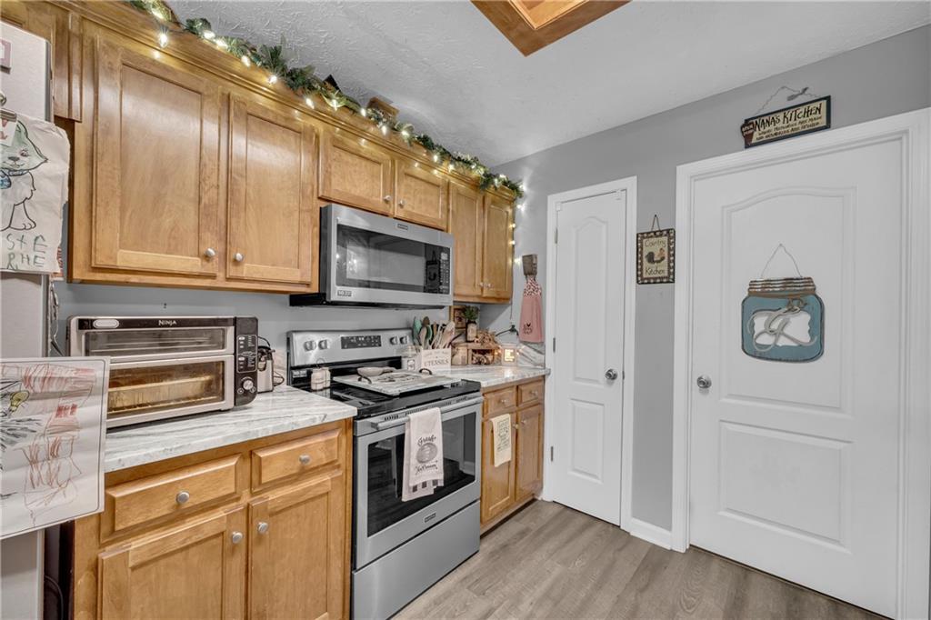 587-j B J B Owens Road Bethlehem, GA 30620 - Photo 33 of 99 a kitchen with stainless steel appliances granite countertop a stove and a microwave