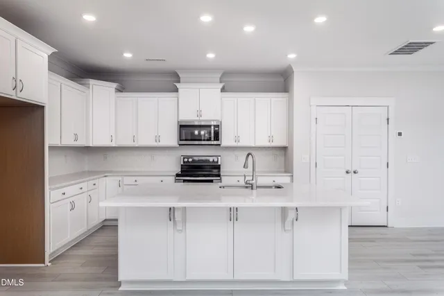 a kitchen with a sink stainless steel appliances and cabinets