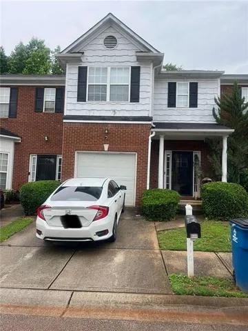 a car parked in front of a brick house