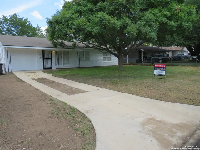 a backyard of a house with table and chairs
