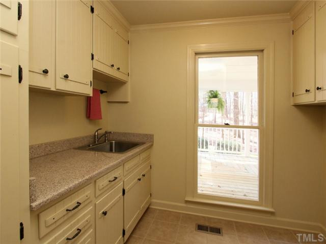 5504 Fallen Leaf Court Raleigh, NC 27606 - Photo 21 of 25 Laundry room with closet, built-ins, granite, utility sink, tile floors