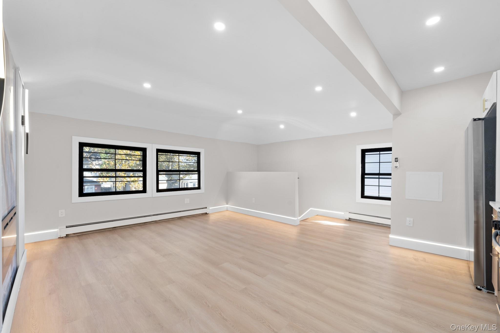 115-16 199th Street Queens, NY 11412 - Photo 12 of 21 Unfurnished living room with a baseboard radiator, recessed lighting, and light wood-style floors
