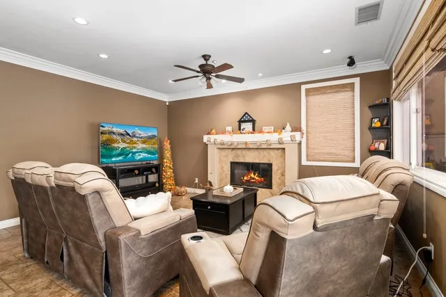 a living room with furniture a flat screen tv and a fireplace