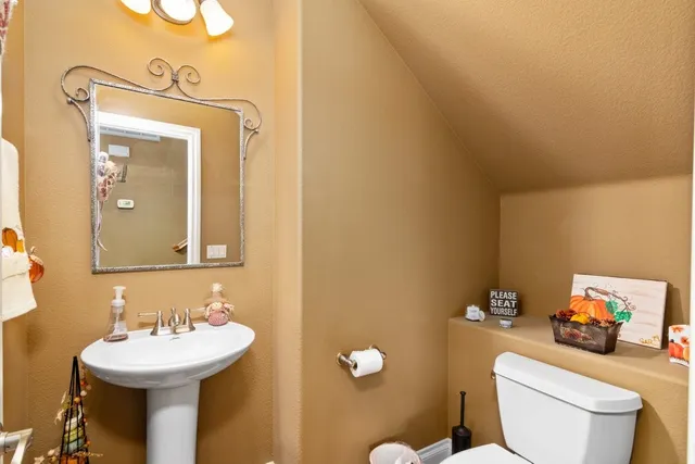 a bathroom with a sink mirror and toilet