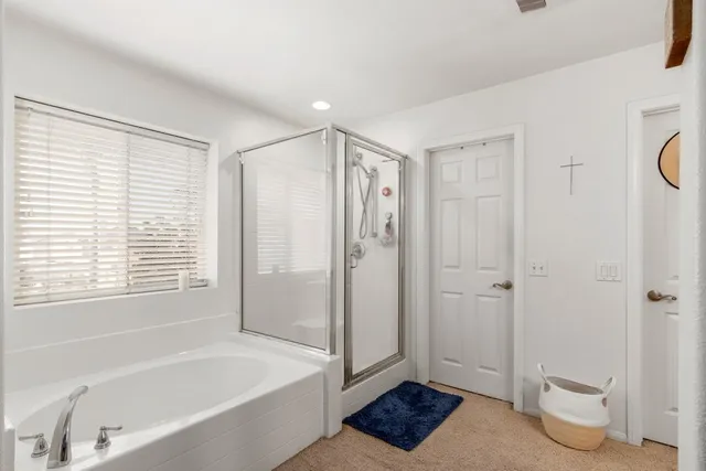 a bathroom with a bathtub a toilet and a shower