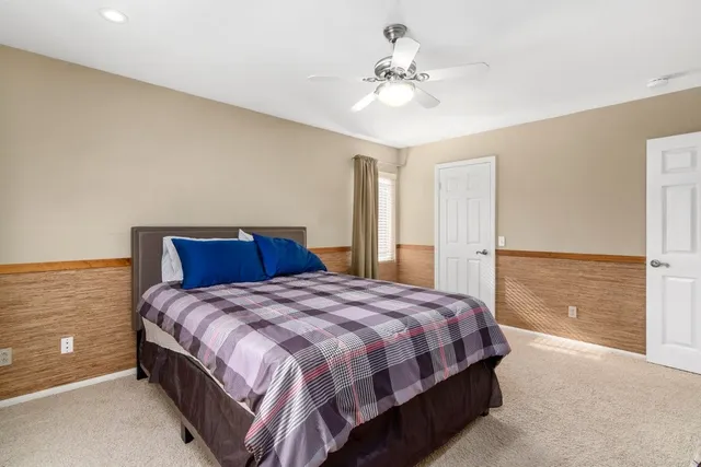 a bedroom with a bed and a chandelier