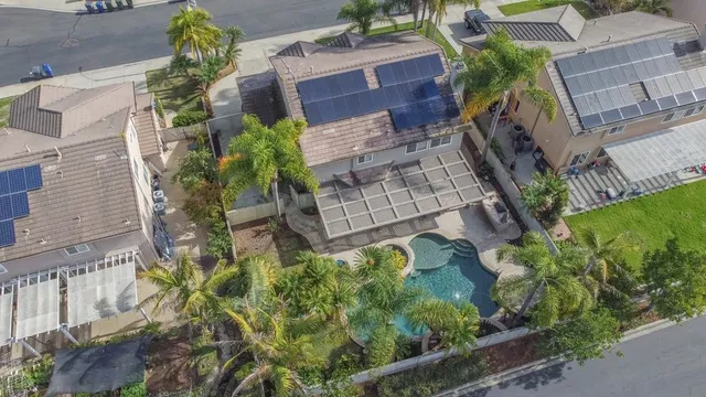 an aerial view of a house with a yard