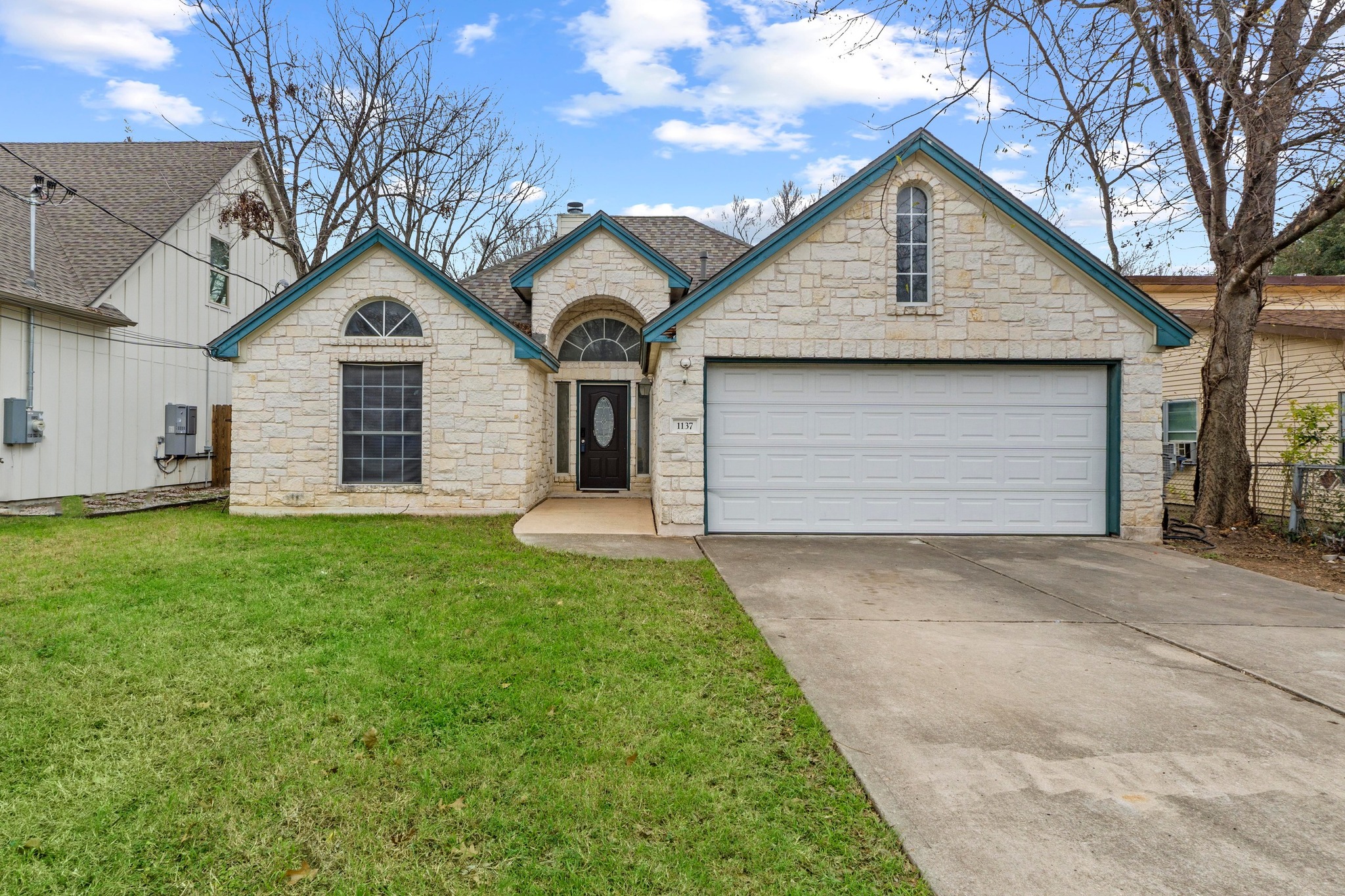 1137 Don Ann Street Austin, TX 78721 - Photo 1 of 1 a front view of a house with a garden and garage