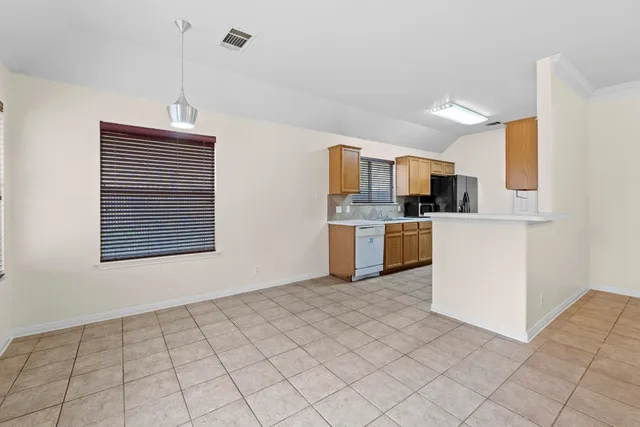 a view of kitchen with granite countertop cabinets and steel appliances