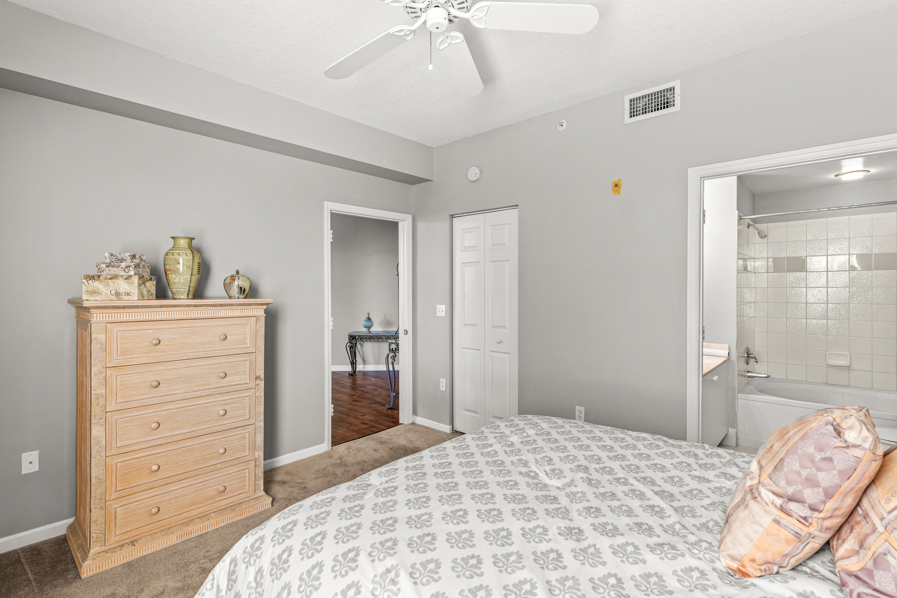 1951 Brandywine Road, Unit 59303 West Palm Beach, FL 33409 - Photo 13 of 25 a bedroom with a bed and a dresser