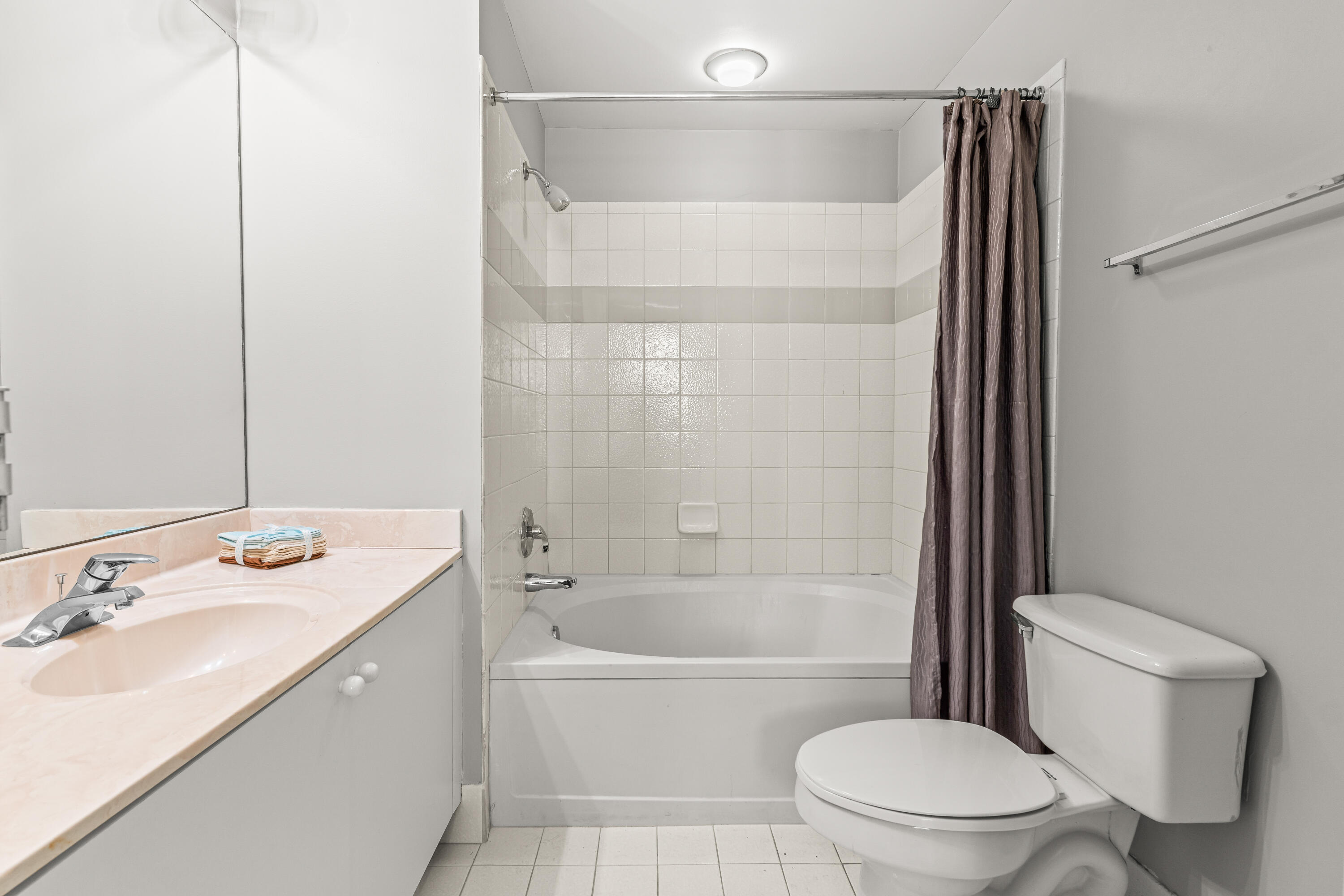 1951 Brandywine Road, Unit 59303 West Palm Beach, FL 33409 - Photo 14 of 25 a bathroom with a sink toilet and shower