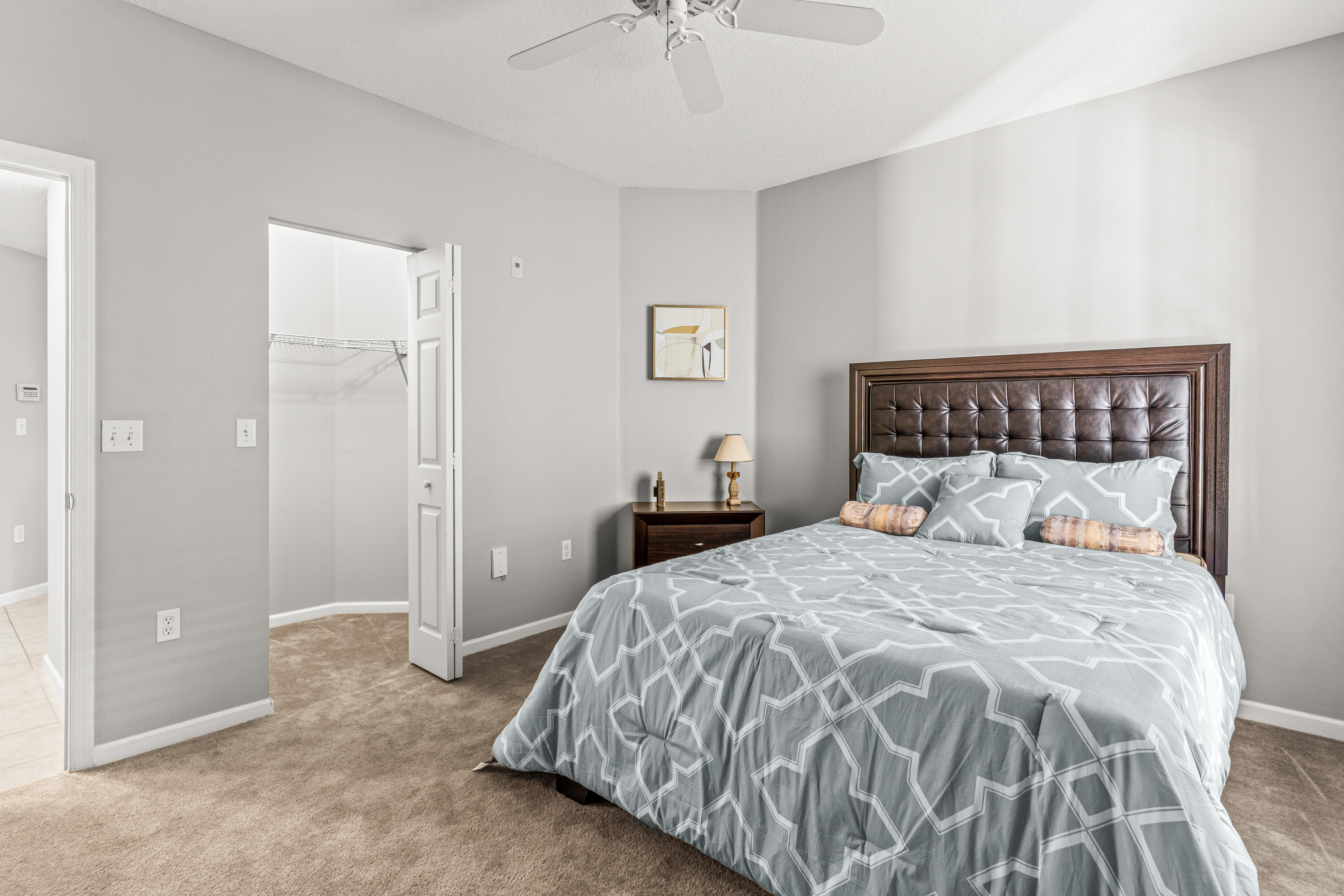 1951 Brandywine Road, Unit 59303 West Palm Beach, FL 33409 - Photo 8 of 25 a bedroom with a bed and a chandelier