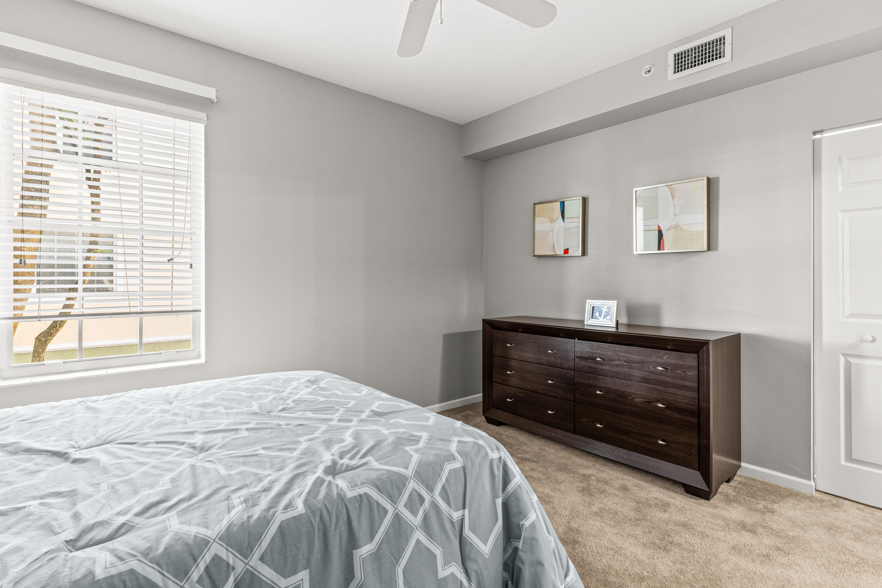 1951 Brandywine Road, Unit 59303 West Palm Beach, FL 33409 - Photo 9 of 25 a bedroom with a bed and a window