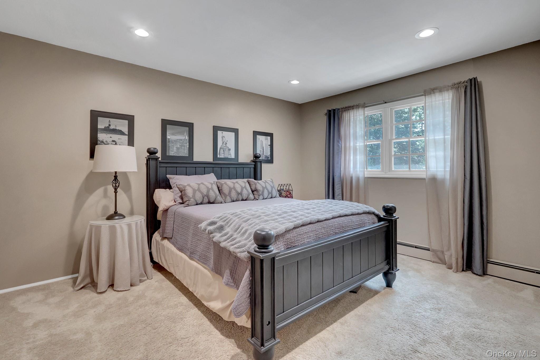 24 Fox Road East Setauket, NY 11733 - Photo 30 of 48 Carpeted room featuring a double-paned window, recessed lighting, and neutral wall paint