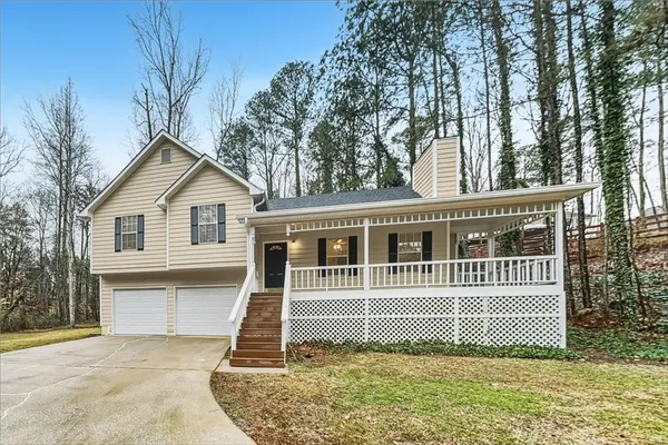 a front view of a house with a garden