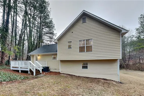 a view of a house with a yard and sitting area