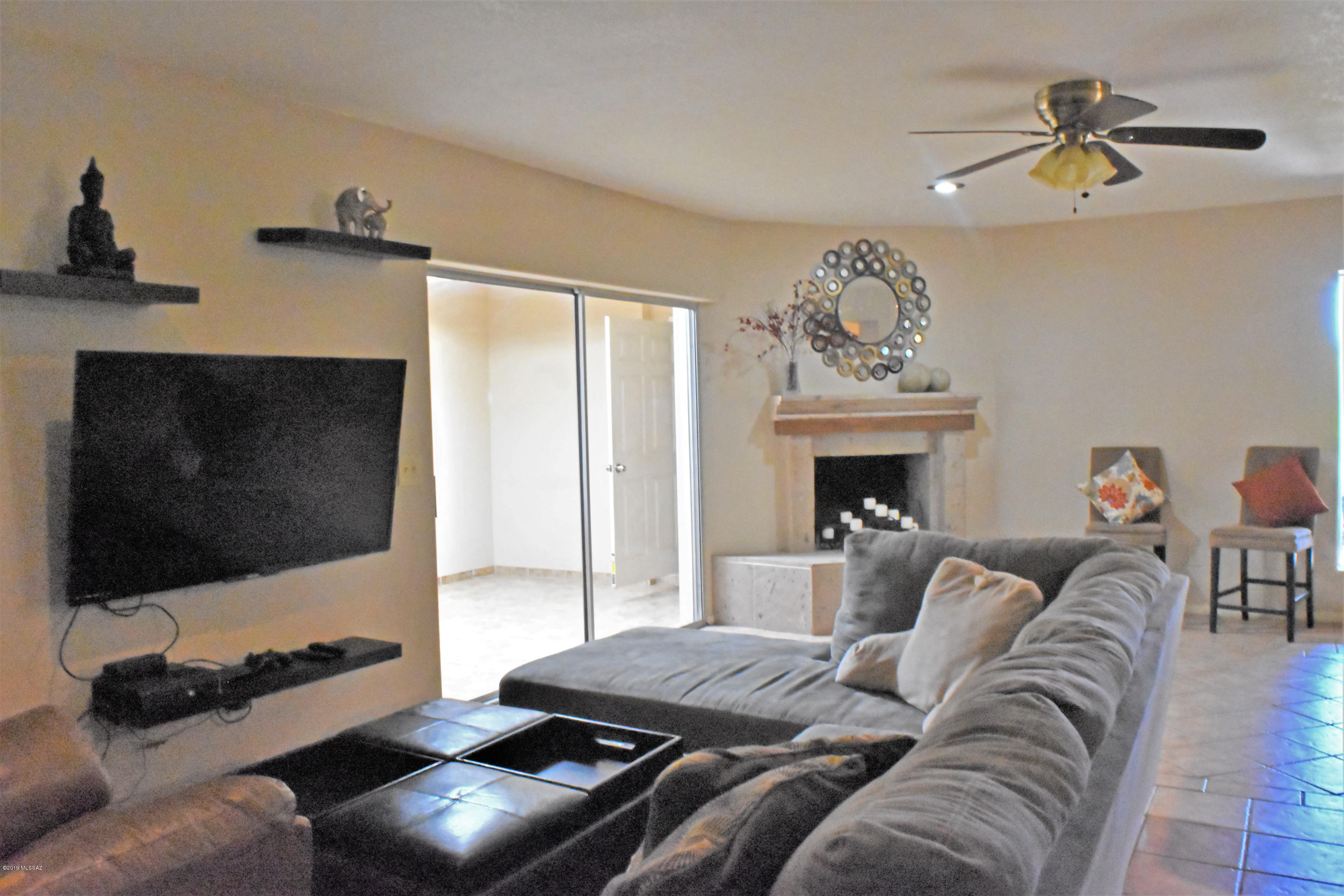 392 Willow Drive Rio Rico, AZ 85648 - Photo 14 of 25 a living room with furniture a flat screen tv and a fireplace