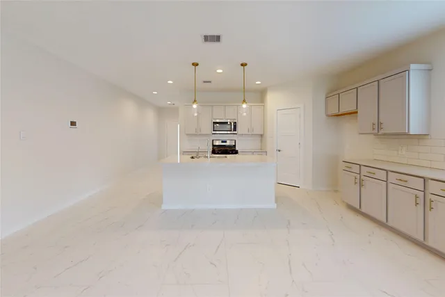 a large white kitchen with a white cabinets