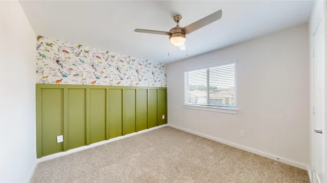 a view of a livingroom with a ceiling fan and window