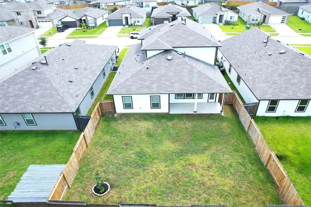 an aerial view of a house with a yard