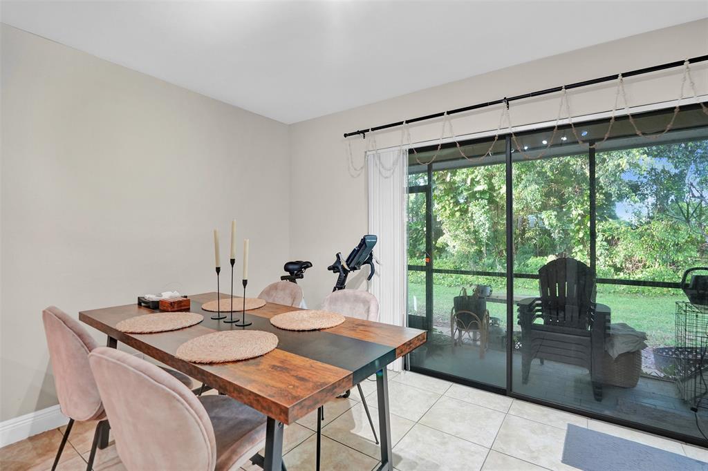 9851 Riverside Drive Coral Springs, FL 33071 - Photo 12 of 35 a view of a dining table and chairs in the patio