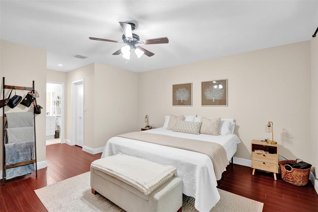 9851 Riverside Drive Coral Springs, FL 33071 - Photo 14 of 35 a bedroom with a bed and wooden floor