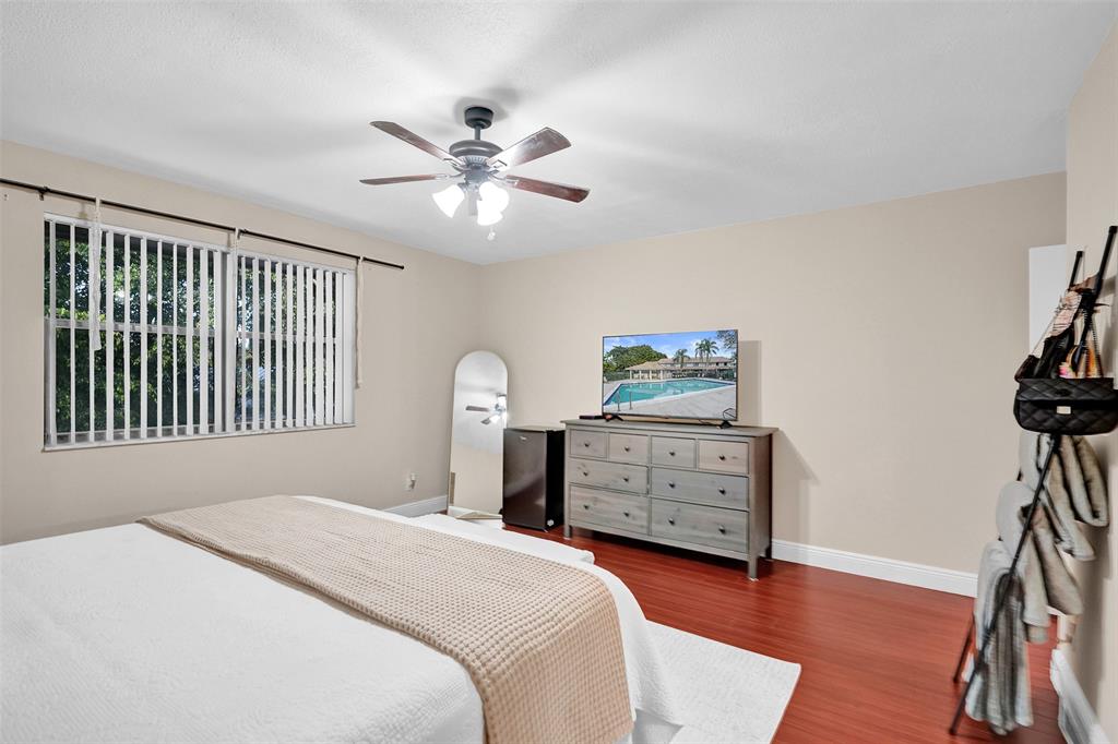 9851 Riverside Drive Coral Springs, FL 33071 - Photo 16 of 35 a bedroom with a bed and a dresser