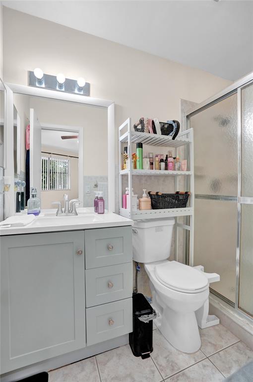 9851 Riverside Drive Coral Springs, FL 33071 - Photo 18 of 35 a bathroom with a sink a toilet and a mirror