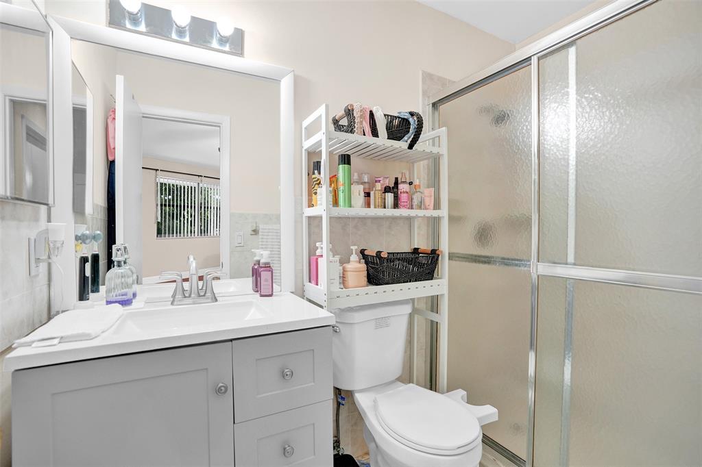 9851 Riverside Drive Coral Springs, FL 33071 - Photo 19 of 35 a bathroom with a sink toilet vanity and shower