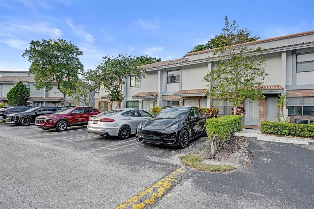 9851 Riverside Drive Coral Springs, FL 33071 - Photo 2 of 35 a view of a car park in front of a house