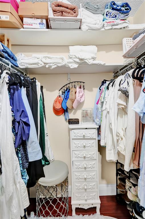 9851 Riverside Drive Coral Springs, FL 33071 - Photo 21 of 35 a view of walk in closet with clothes and shoes