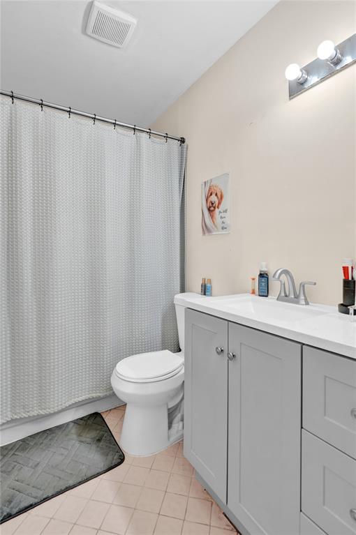 9851 Riverside Drive Coral Springs, FL 33071 - Photo 25 of 35 a bathroom with a sink mirror and toilet