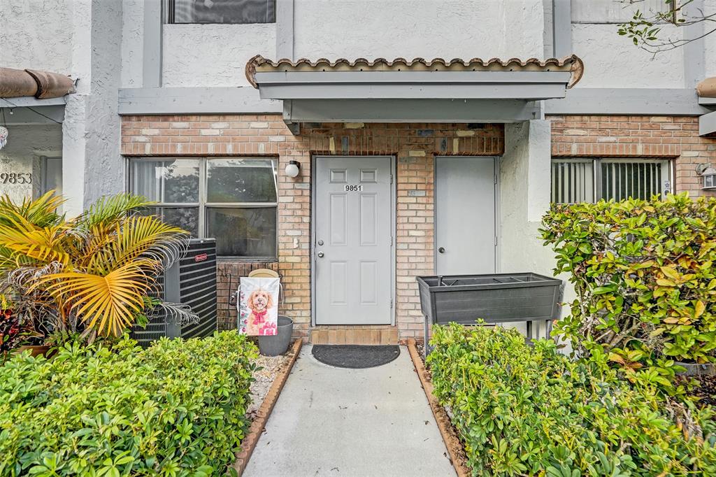 9851 Riverside Drive Coral Springs, FL 33071 - Photo 3 of 35 a front view of a house with garden