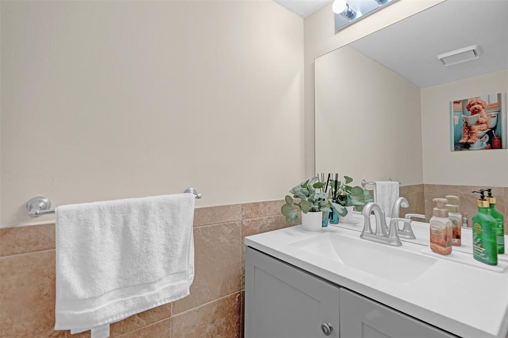 9851 Riverside Drive Coral Springs, FL 33071 - Photo 31 of 35 a bathroom with a sink and a mirror