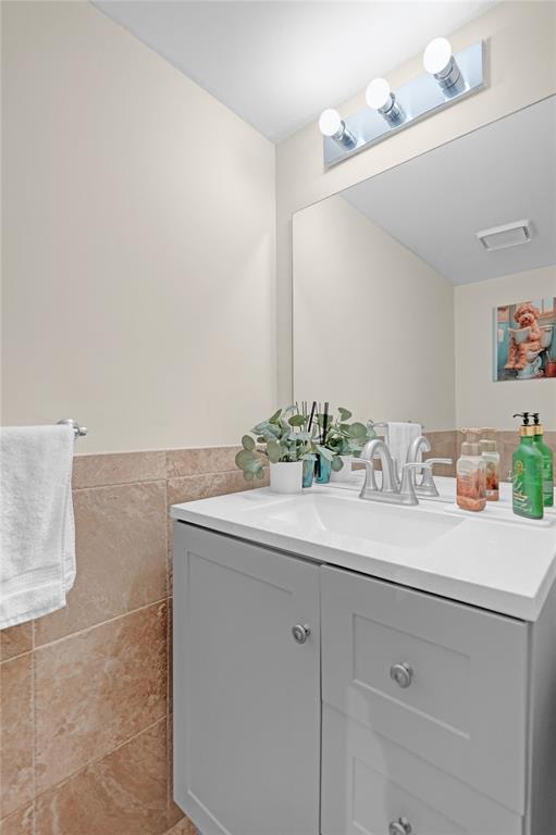 9851 Riverside Drive Coral Springs, FL 33071 - Photo 32 of 35 a bathroom with a granite countertop sink and a mirror