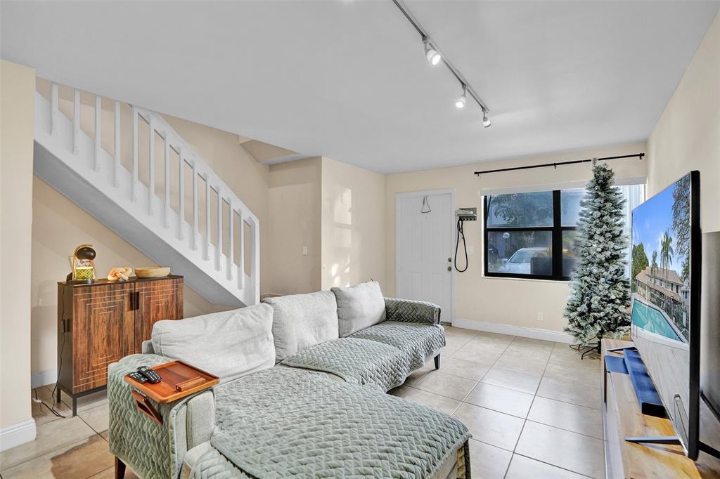 9851 Riverside Drive Coral Springs, FL 33071 - Photo 4 of 35 a living room with furniture potted plant and a flat screen tv