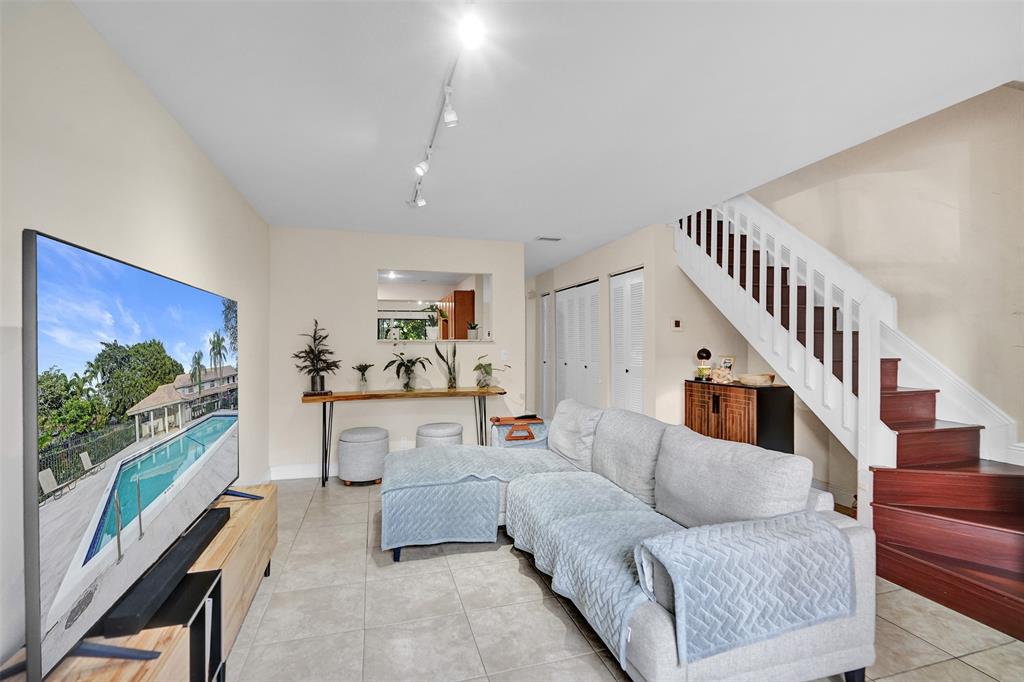 9851 Riverside Drive Coral Springs, FL 33071 - Photo 6 of 35 a living room with furniture and a flat screen tv