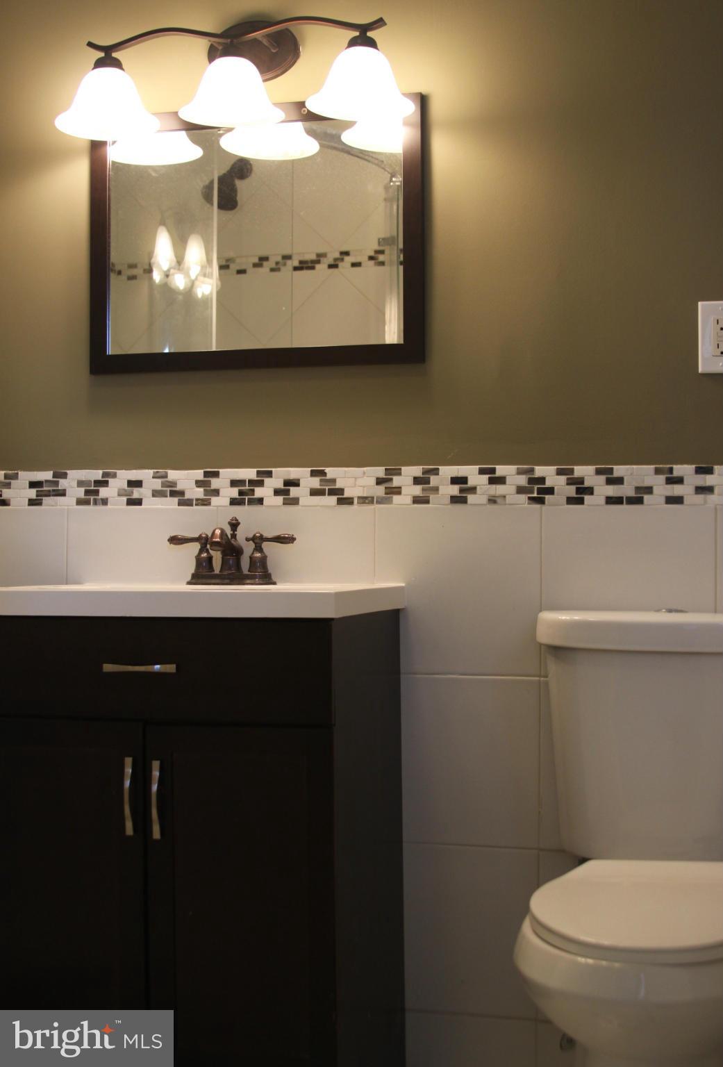 2016 Greengage Road Baltimore, MD 21244 - Photo 11 of 26 a bathroom with a sink mirror and toilet