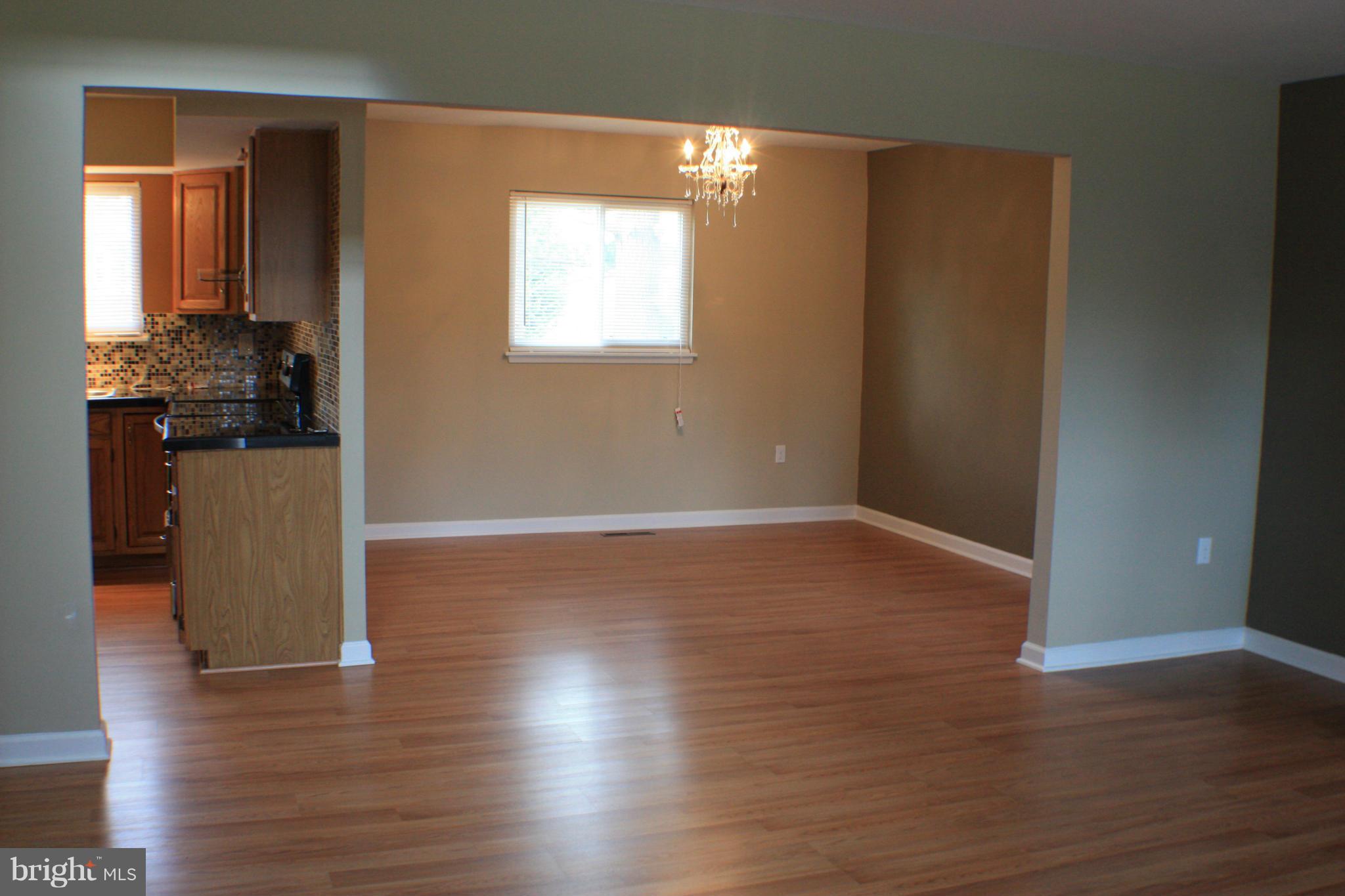 2016 Greengage Road Baltimore, MD 21244 - Photo 4 of 26 a view of a livingroom with wooden floor and a window