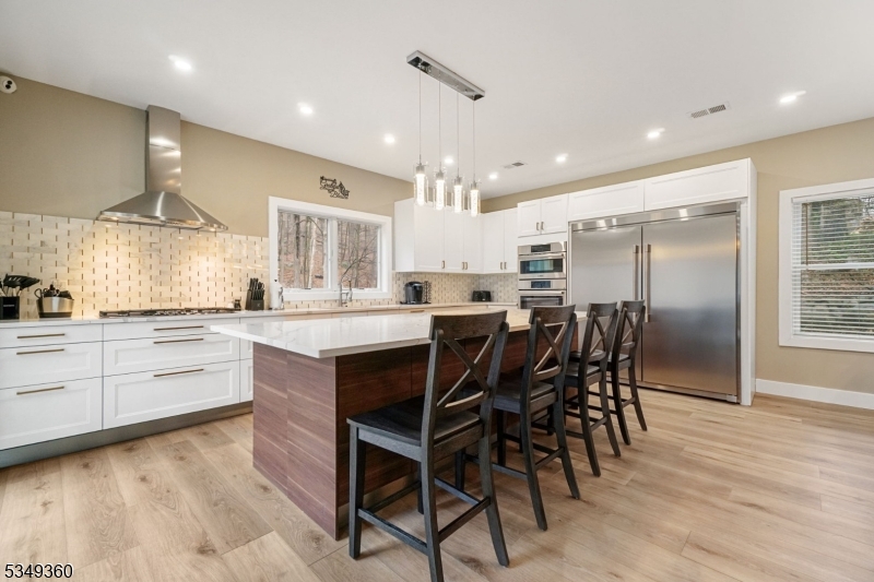 232 Kinnelon Road Kinnelon, NJ 07405 - Photo 11 of 43 a kitchen with stainless steel appliances kitchen island granite countertop a table chairs sink and cabinets