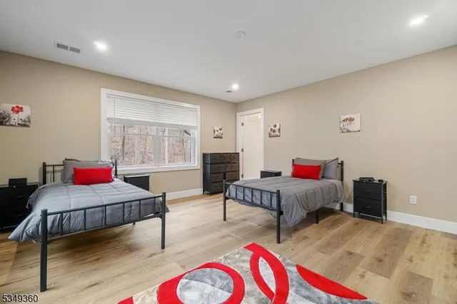 a bedroom with furniture and a wooden floor