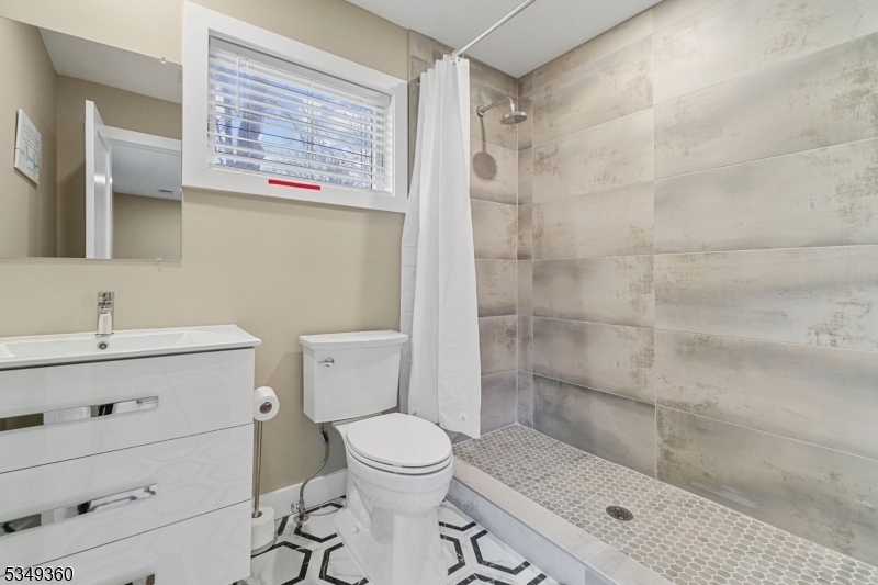 232 Kinnelon Road Kinnelon, NJ 07405 - Photo 17 of 43 a bathroom with a sink a toilet and shower