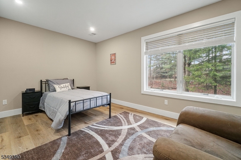 232 Kinnelon Road Kinnelon, NJ 07405 - Photo 19 of 43 a bedroom with a bed and wooden floor