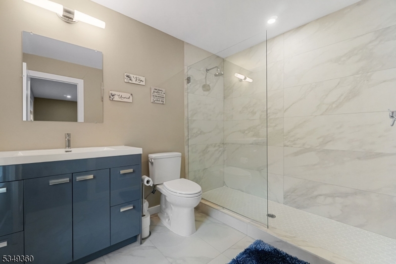 232 Kinnelon Road Kinnelon, NJ 07405 - Photo 26 of 43 a bathroom with a sink toilet a mirror and shower