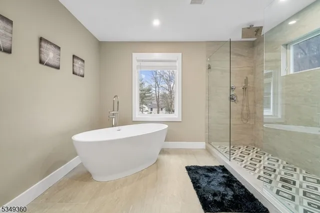 a bathroom with a bathtub and shower