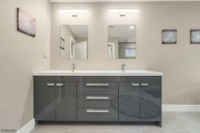 a bathroom with a sink vanity and mirror
