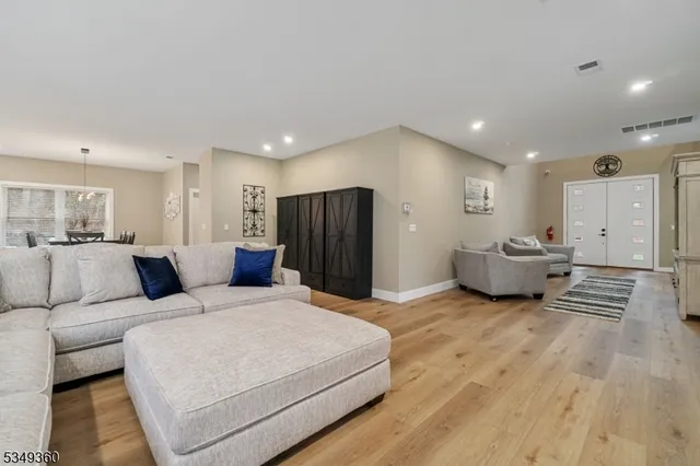 a large bedroom with a bed and a refrigerator