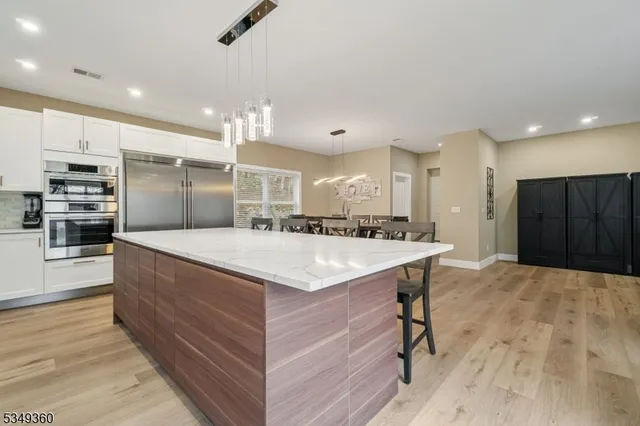 a large kitchen with a stove a refrigerator and a sink